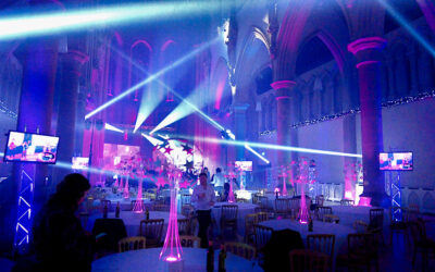 Gorton Monastery Manchester Event Lighting Multi Blue moving beams LED TV's on stands and arches lit with colour wash