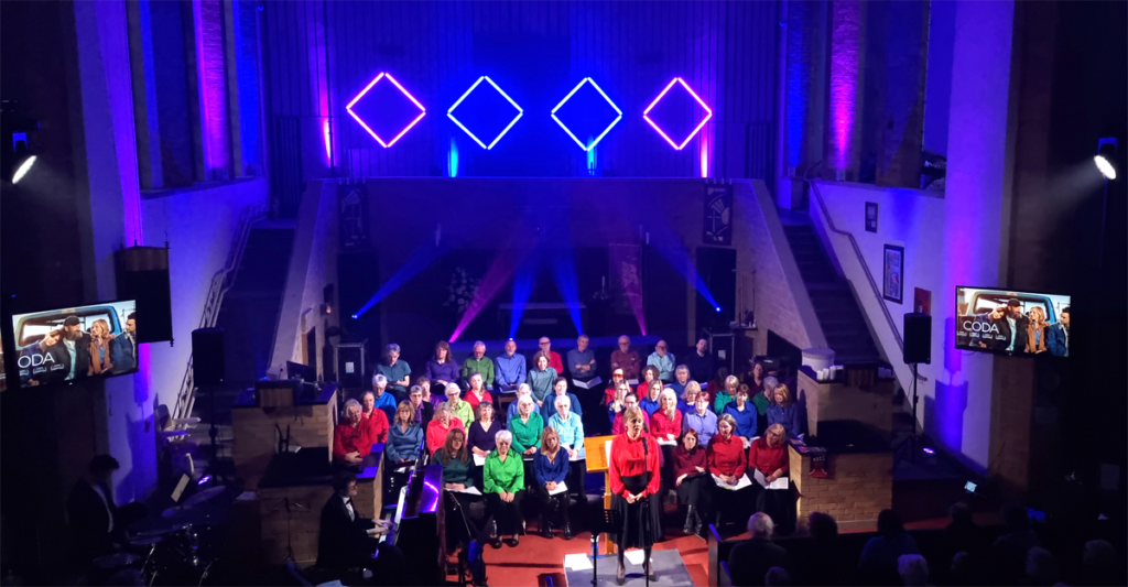 A choir lit up with white light, surrounded by effect lighting and Astera pixel tubes.